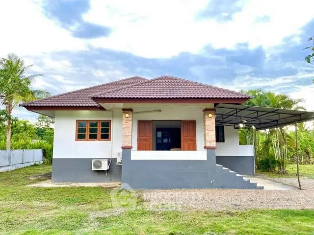Charming single-story home with a spacious yard and covered carport, perfect for family living.