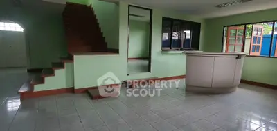 Spacious interior with tiled flooring and staircase, ideal for modern living.