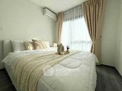 Bright and cozy bedroom with large window and elegant decor