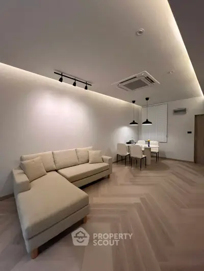 Modern living room with stylish lighting and cozy beige sofa