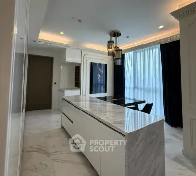 Luxurious modern kitchen with marble island and elegant lighting