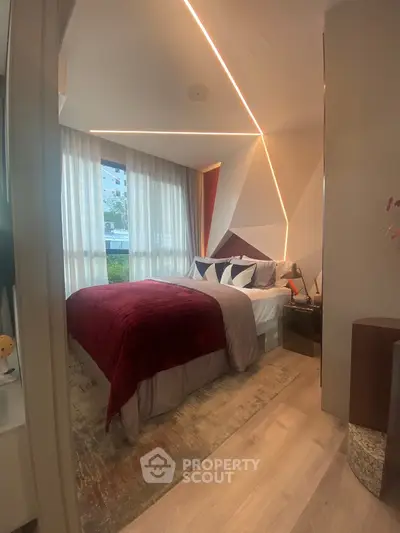 Modern bedroom with stylish geometric wall design and cozy lighting