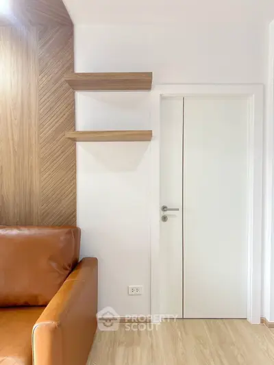 Modern living room with sleek wooden shelves and stylish leather sofa