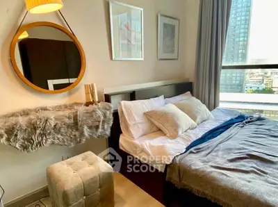 Cozy modern bedroom with city view, stylish decor, and natural light.