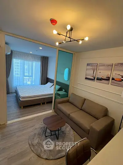 Modern studio apartment with cozy living area and stylish bedroom, featuring elegant decor and natural light.