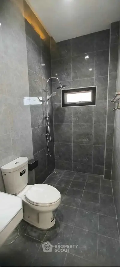 Modern bathroom with sleek gray tiles and contemporary fixtures