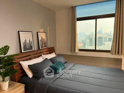 Modern bedroom with city view, stylish decor, and natural light.