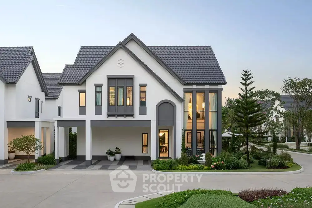 Elegant modern house with large windows and landscaped garden in a serene neighborhood.