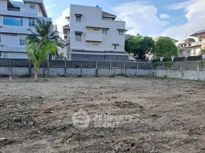 Vacant land plot in urban area with potential for development, surrounded by residential buildings.