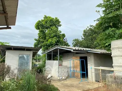 Charming rural property with lush greenery and rustic outbuildings, perfect for serene living.