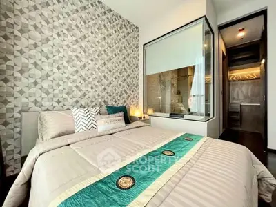 Luxurious bedroom with modern decor and walk-in closet in upscale apartment.