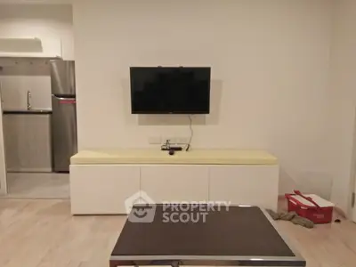 Modern living room with wall-mounted TV and sleek furniture design