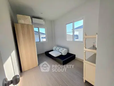 Cozy minimalist bedroom with natural light and compact storage solutions