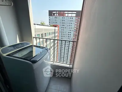 Compact balcony with washing machine and city view in modern apartment