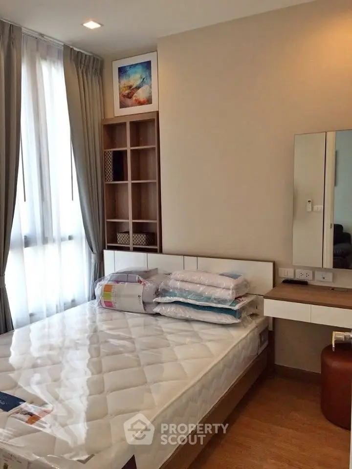 Cozy bedroom with modern furnishings and natural light, perfect for relaxation and comfort.