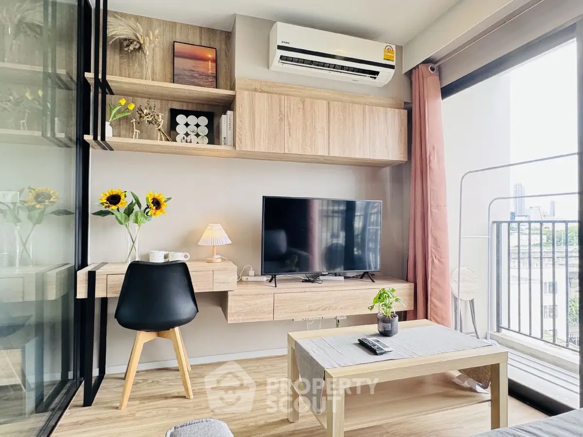Modern living room with stylish decor, TV, and balcony view in a chic apartment.