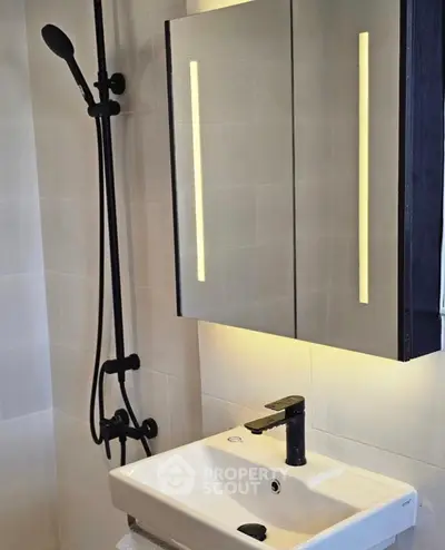 Modern bathroom with sleek fixtures and illuminated mirror