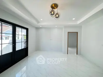 Spacious modern living room with elegant lighting and large windows