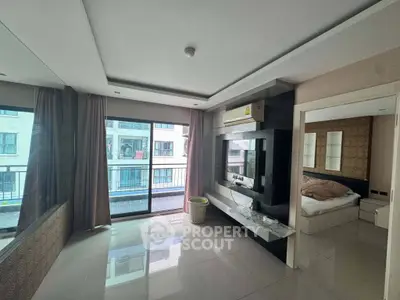 Spacious modern living room with large windows and sleek design in a contemporary apartment.