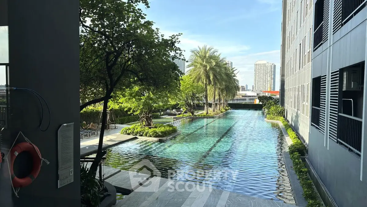 Luxurious condominium pool with lush greenery and city view