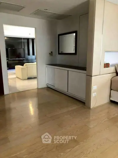 Spacious modern living room with wooden flooring and elegant decor