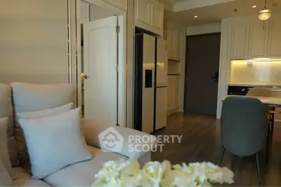 Modern open-layout living room and kitchen with elegant decor and appliances