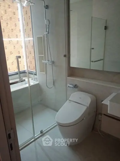 Modern bathroom with sleek fixtures and glass shower enclosure