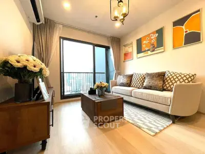 Stylish living room with modern decor and large window offering natural light.