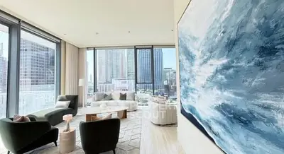 Luxurious modern living room with stunning city view and elegant decor.