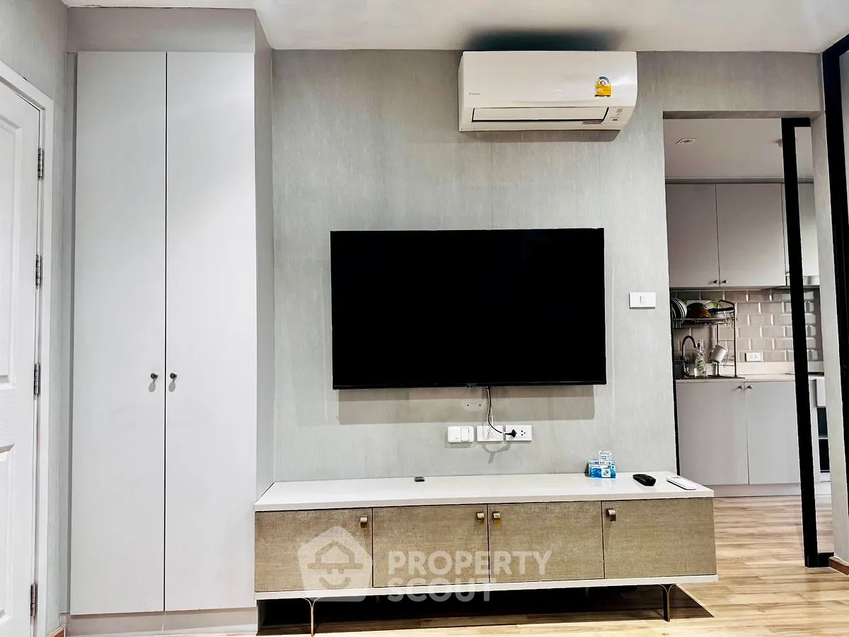 Modern living room with wall-mounted TV and air conditioning unit