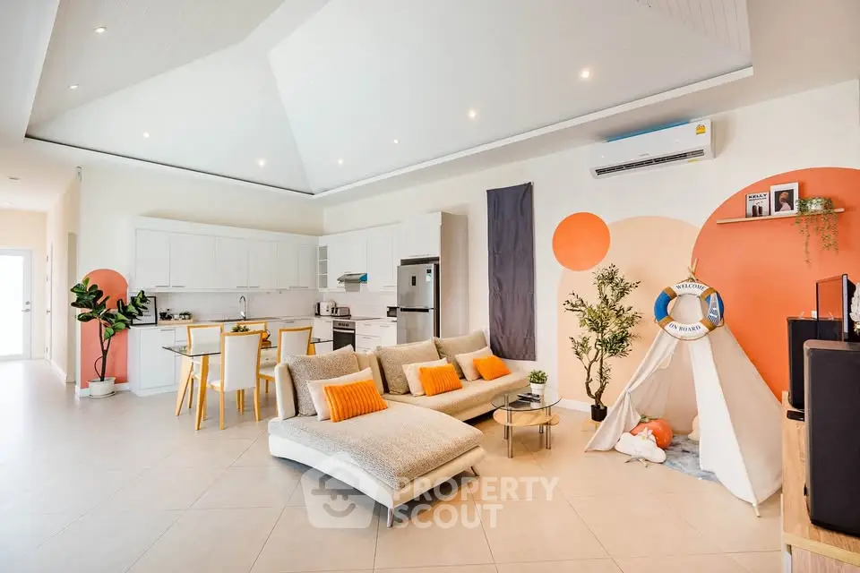 Modern open-plan living room with stylish decor and bright accents