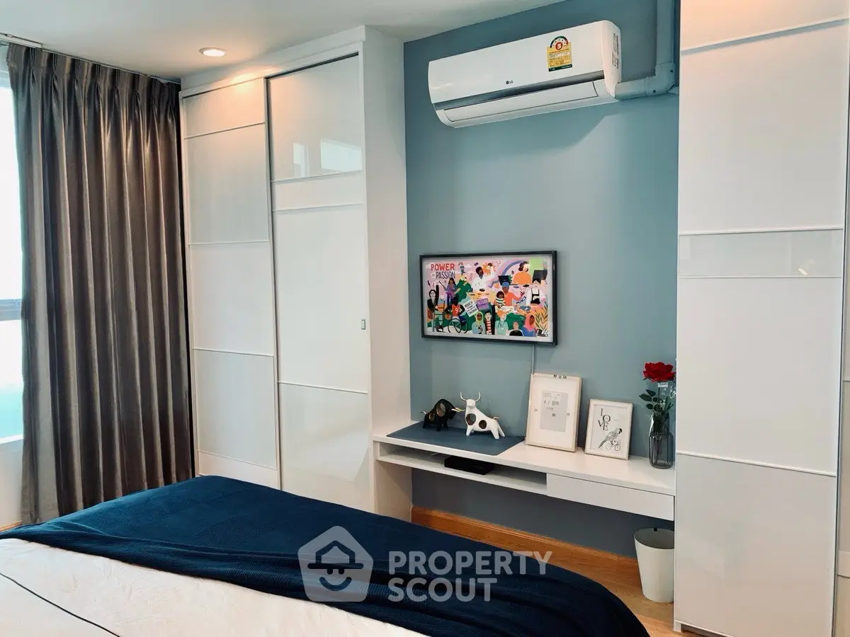 Modern bedroom with sleek design, featuring built-in wardrobe and air conditioning for ultimate comfort.