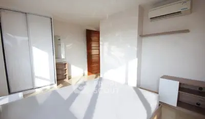 Bright minimalist bedroom with air conditioning and modern furniture