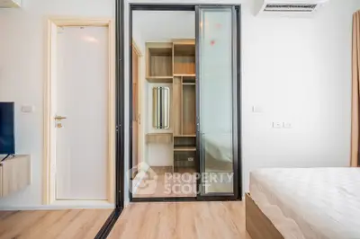 Modern bedroom with sliding glass door and built-in wardrobe