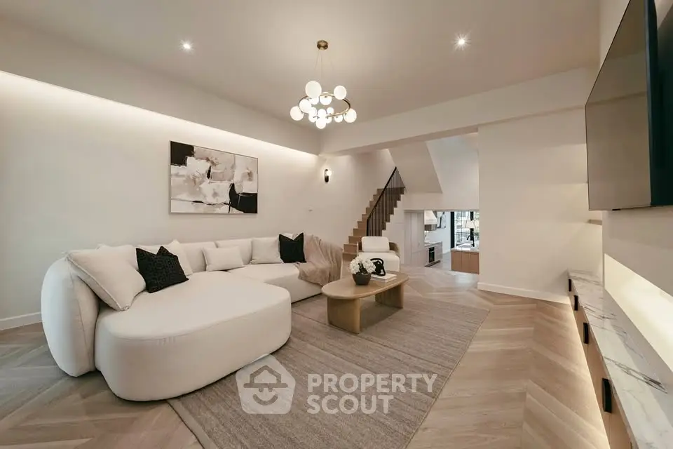 Luxurious modern living room with elegant decor and spacious layout, featuring stylish furniture and ambient lighting.