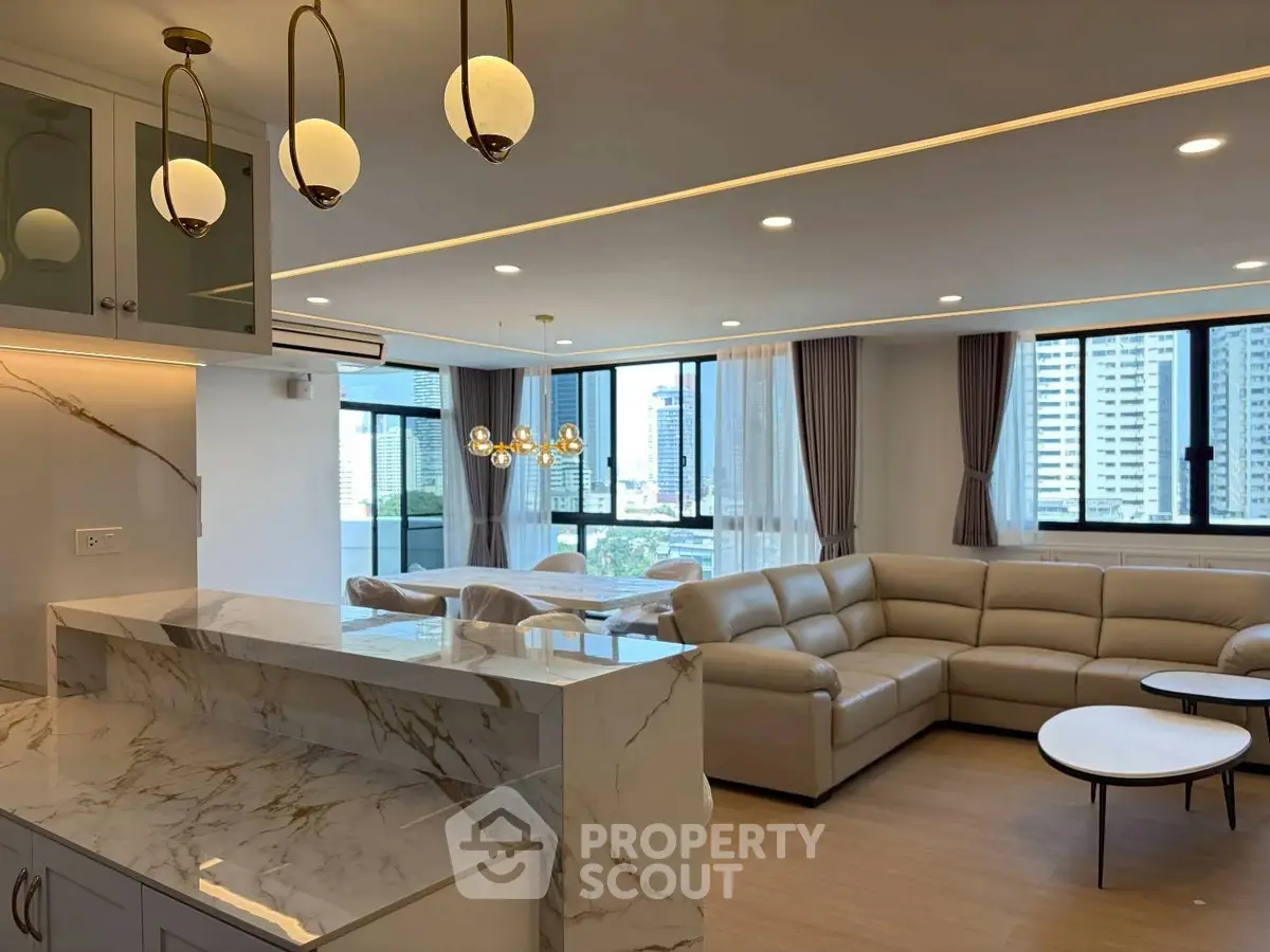 Luxurious open-plan living room with modern decor and city view