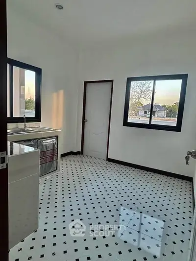 Spacious kitchen with modern design and large windows for natural light.