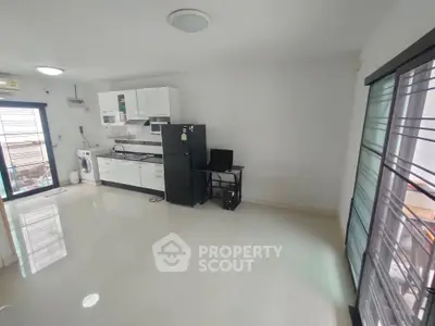 Spacious modern kitchen with sleek appliances and ample natural light.