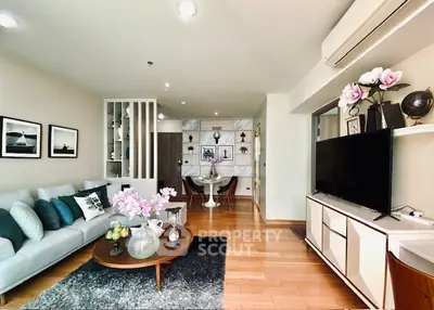 Elegant living room with modern decor and open layout, featuring stylish furniture and natural light.
