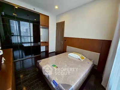 Modern bedroom with sleek design and large mirrored wardrobe