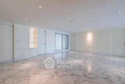 Spacious marble-floored living room with elegant lighting and modern design.