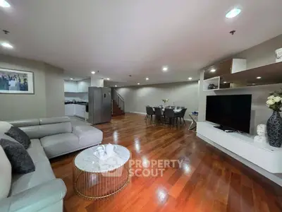 Spacious modern living room with open layout and elegant wooden flooring
