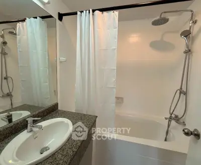 Modern bathroom with granite countertop and sleek shower design