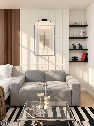 Modern living room with stylish gray sofa, wall art, and decorative shelves.