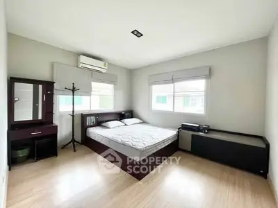 Spacious bedroom with modern furnishings and natural light