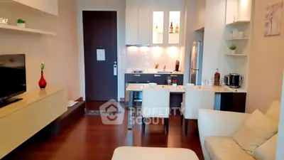 Modern living room with open kitchen layout and stylish decor