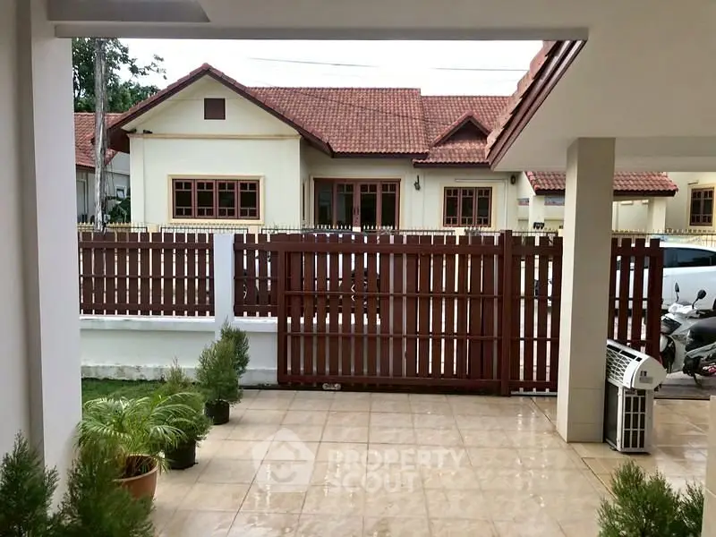 Charming residential view with tiled patio and traditional house exterior.