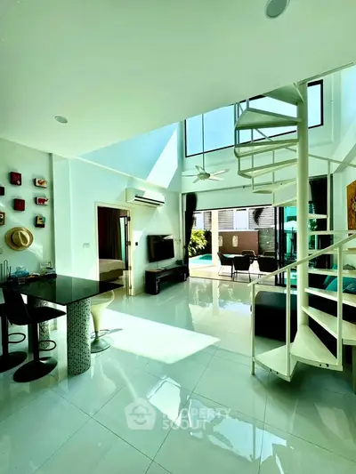 Stunning modern living room with spiral staircase and abundant natural light