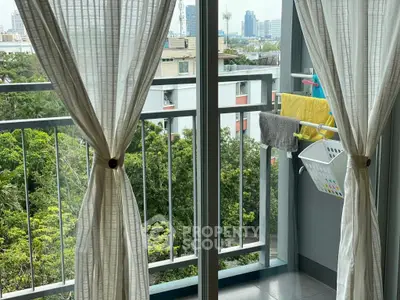 Charming balcony view with lush greenery and cityscape, perfect for relaxation and enjoying the outdoors.