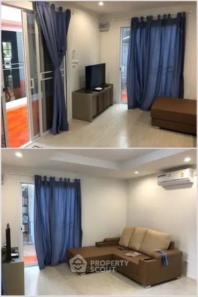 Modern living room with blue curtains and brown sofa, featuring a sleek TV setup.